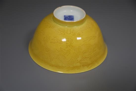 A Chinese yellow glazed sgraffito dragon bowl, Qianlong seal mark and of the period (1736-95), Diam.13.3cm, restored